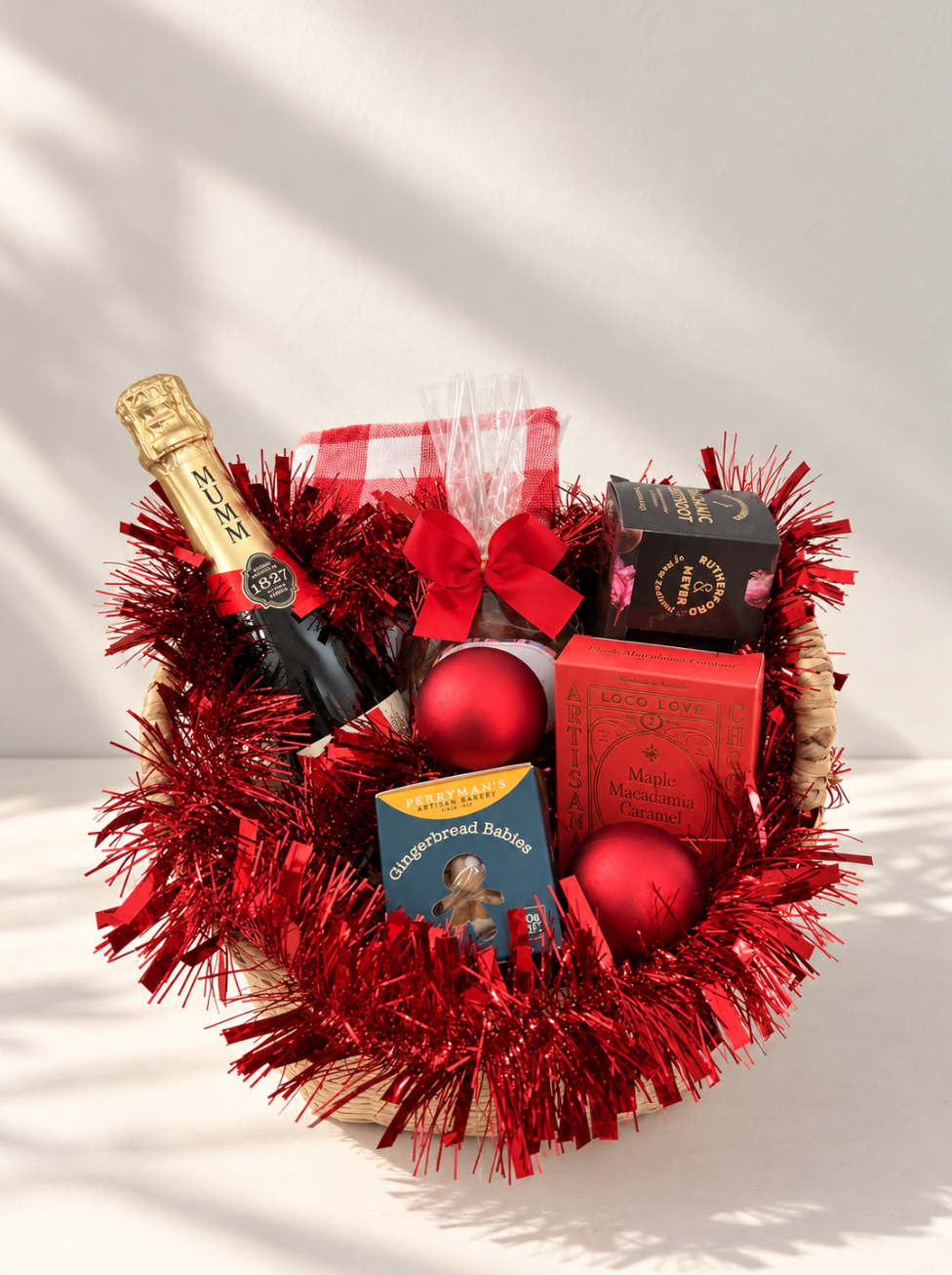 Hamp It Up x Kemeny’s Mumm champagne Christmas hamper with G.H. Mumm Cordon Rouge, roasted macadamias, Perryman’s gingerbread babies, chocolates and red gingham tea towel