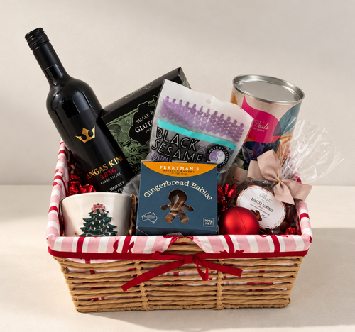 Hamp It Up x Kemeny’s Angas King Shiraz Christmas hamper with Clare Valley Shiraz, Paul’s chocolates, Perryman’s gingerbread babies, crackers and Christmas tree candle in a striped woven basket