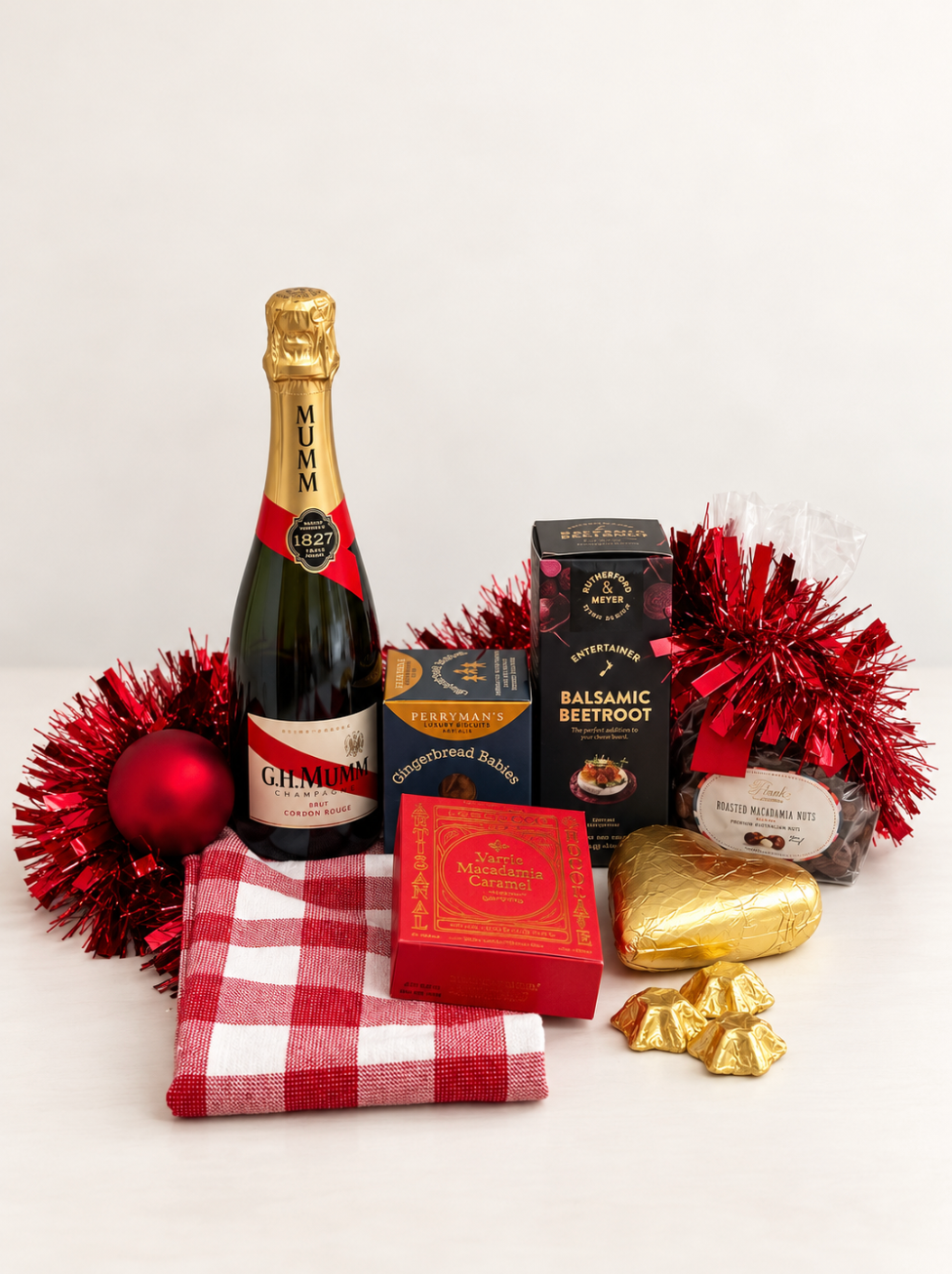 Hamp It Up x Kemeny’s Mumm champagne Christmas hamper with G.H. Mumm Cordon Rouge, roasted macadamias, Perryman’s gingerbread babies, chocolates and red gingham tea towel
