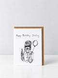 See Aiche Happy Birthday Darling greeting card with a hand-drawn glamorous woman with a beehive, sunglasses and hoop earrings, holding a bottle, a cigarette and a balloon, with a kraft envelope