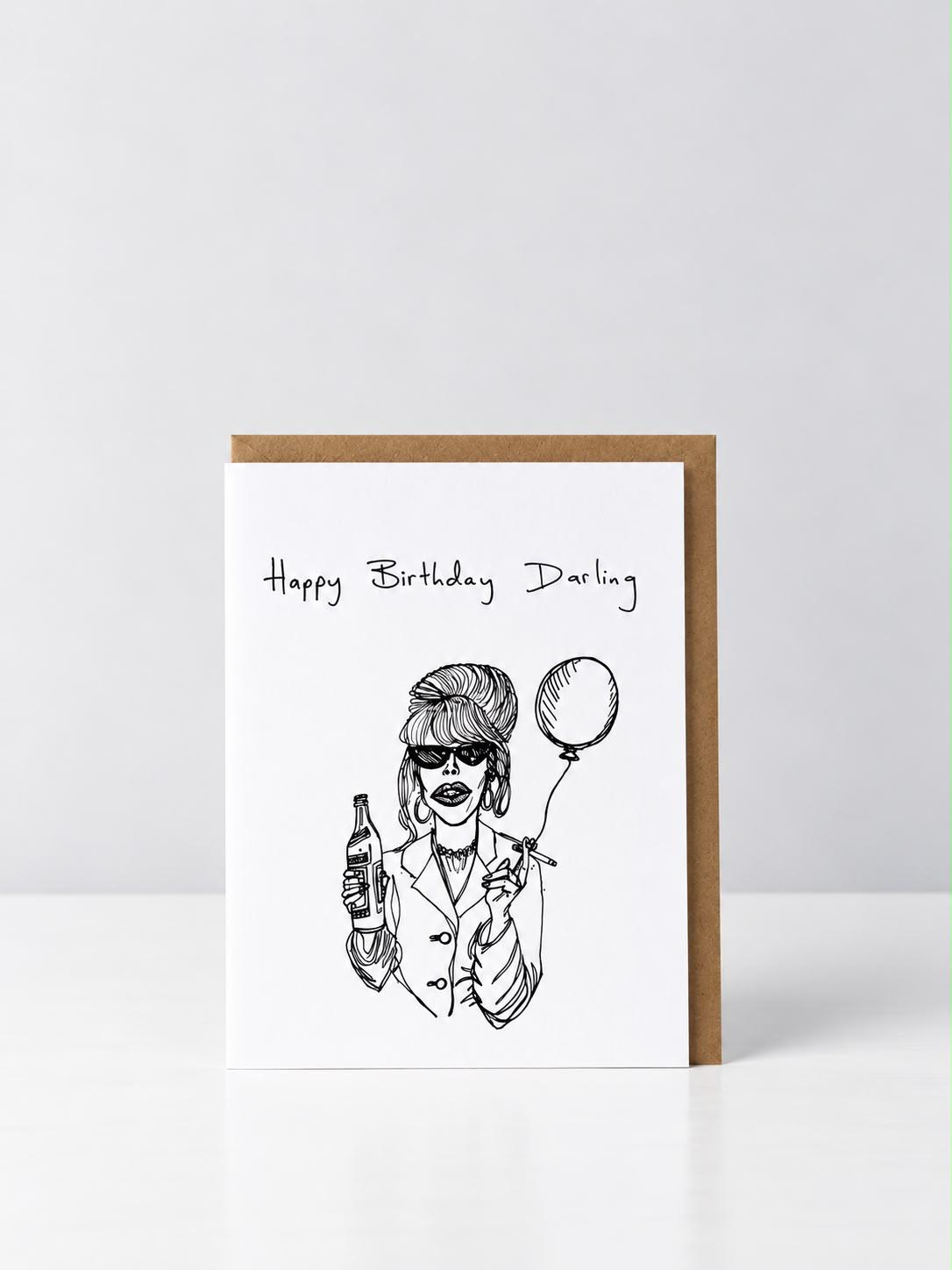 See Aiche Happy Birthday Darling greeting card with a hand-drawn glamorous woman with a beehive, sunglasses and hoop earrings, holding a bottle, a cigarette and a balloon, with a kraft envelope