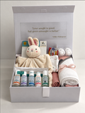 Welcome Baby Girl gift hamper in a white keepsake box with hooded baby towel, comforter, muslin wrap, NUK soothers and GAIA Natural Baby starter kit